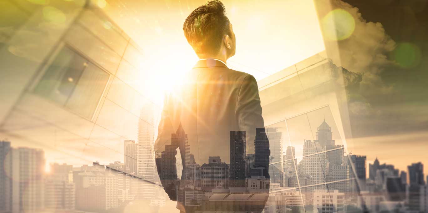 self-driven confident man looking at a city through his office window