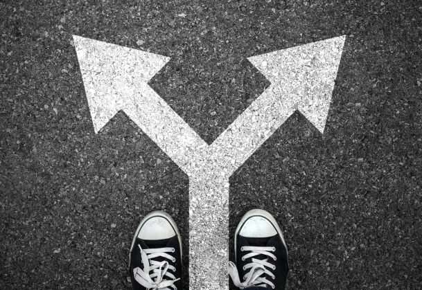 a person's feet at a cross road