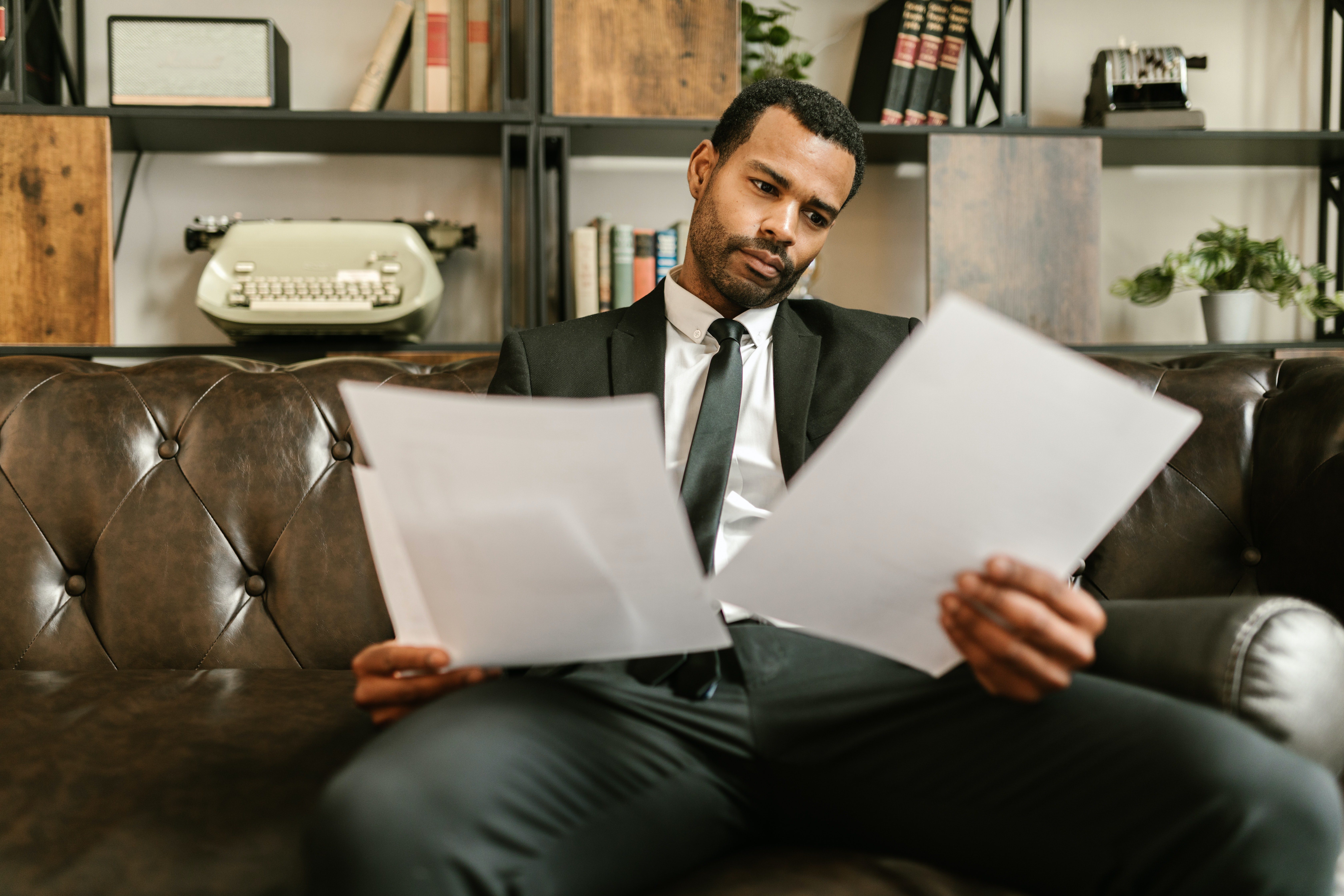 businessman looking at business documents looking tired